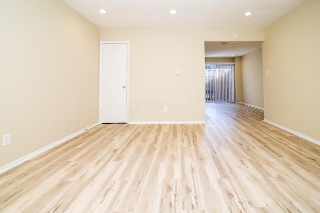 unfurnished room with recessed lighting, light wood-style flooring, and baseboards