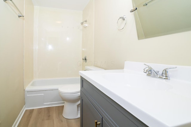 full bath featuring toilet,  shower combination, wood finished floors, and vanity