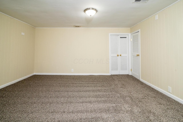 carpeted spare room with baseboards and visible vents