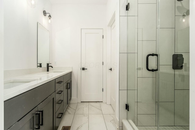 bathroom featuring a stall shower, marble finish floor, a sink, and double vanity