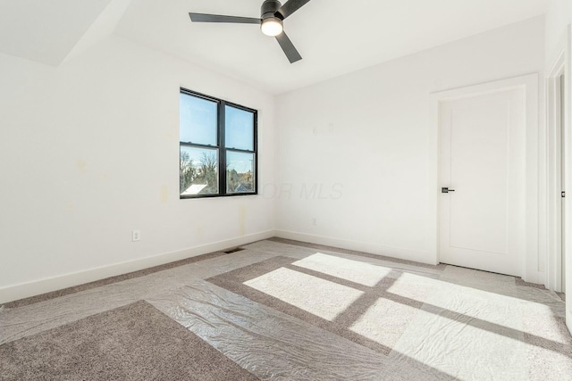 empty room featuring visible vents, ceiling fan, and baseboards