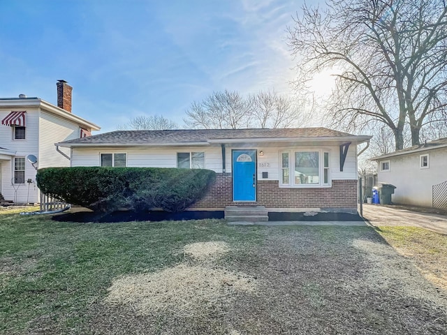 view of front of property with brick siding and a front lawn