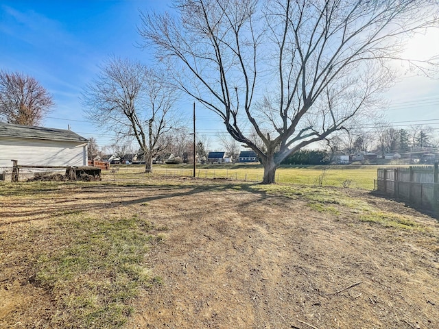 view of yard featuring a rural view and fence