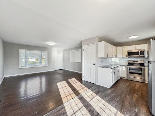 kitchen with white cabinetry, dark wood-style floors, backsplash, and stainless steel appliances