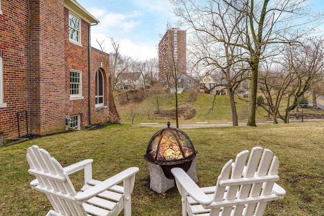 view of yard with a fire pit