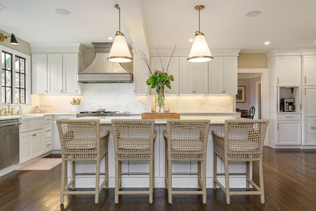 kitchen featuring stainless steel dishwasher, a kitchen island, custom exhaust hood, and dark wood finished floors