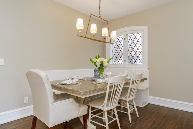 dining room featuring baseboards and wood finished floors