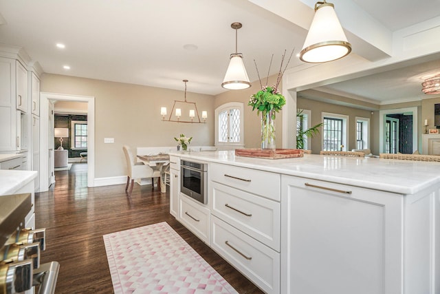 kitchen featuring recessed lighting, white cabinets, dark wood finished floors, and hanging light fixtures