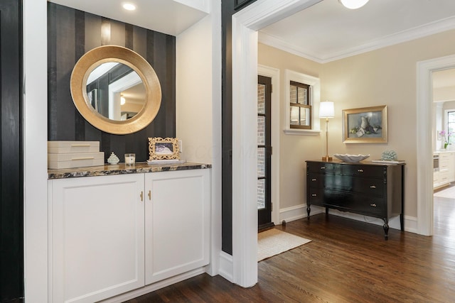 interior space featuring baseboards, ornamental molding, wood finished floors, and vanity