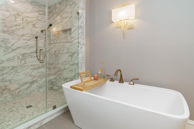 full bath with a soaking tub and a marble finish shower