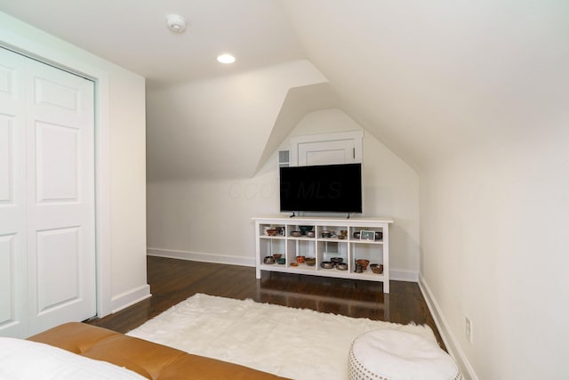 interior space featuring lofted ceiling, recessed lighting, wood finished floors, and baseboards