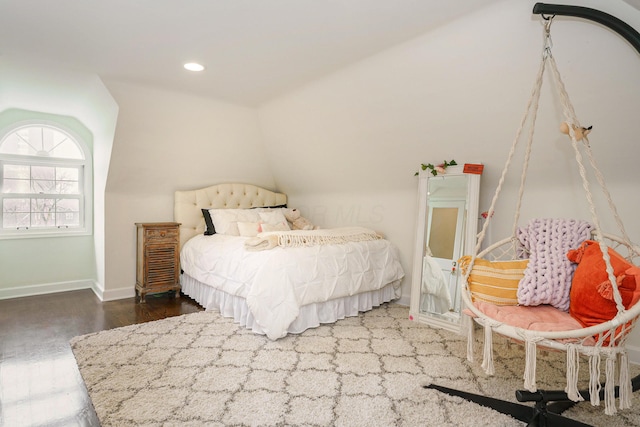 bedroom with vaulted ceiling, recessed lighting, wood finished floors, and baseboards