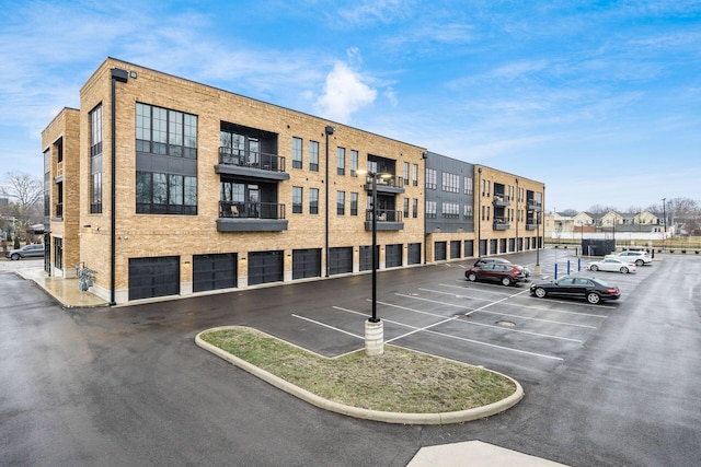 view of building exterior with uncovered parking