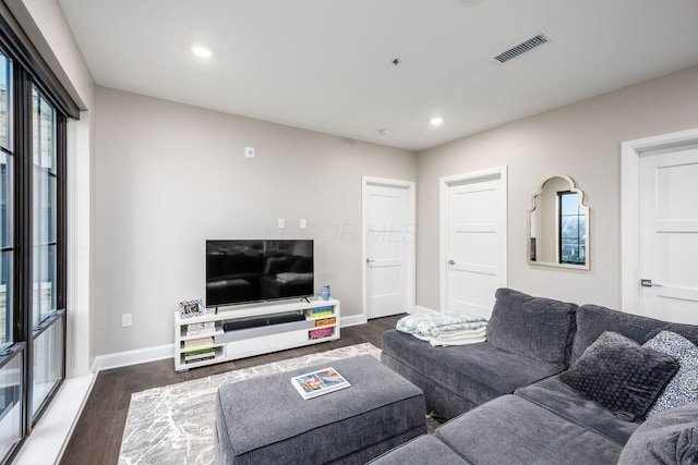 living area with recessed lighting, dark wood-style flooring, visible vents, and baseboards