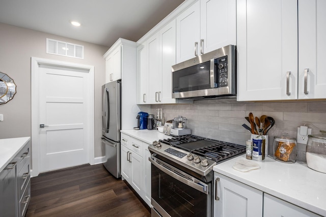 kitchen featuring stainless steel appliances, light countertops, and visible vents