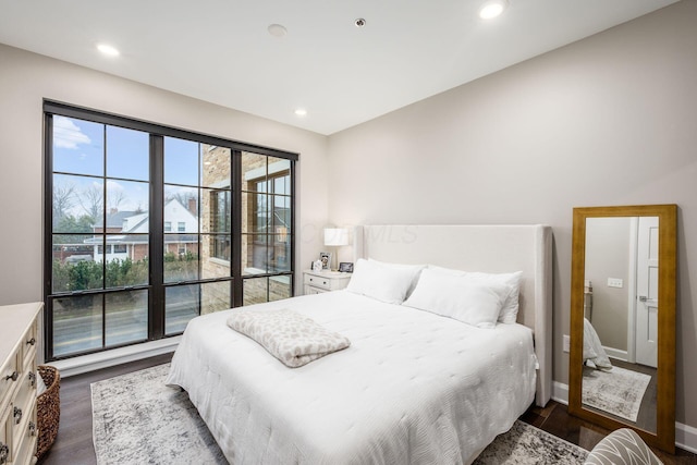 bedroom with baseboards, dark wood-style flooring, and recessed lighting