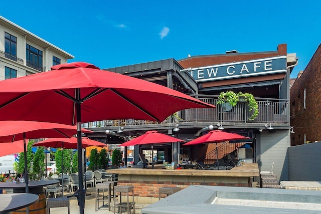 view of community featuring a patio area and outdoor dry bar