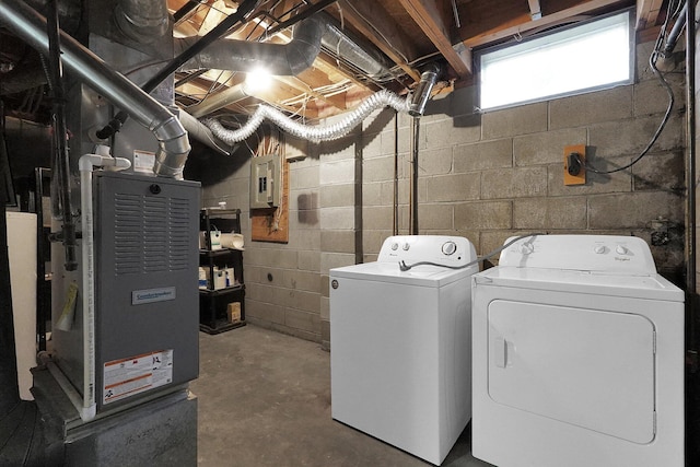 laundry room featuring laundry area, electric panel, and washer and clothes dryer