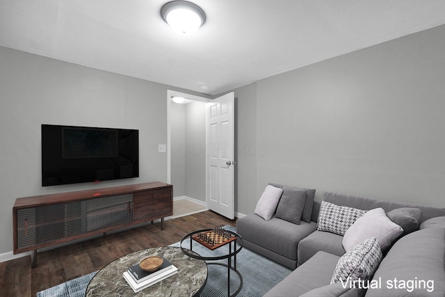 living area featuring baseboards and wood finished floors