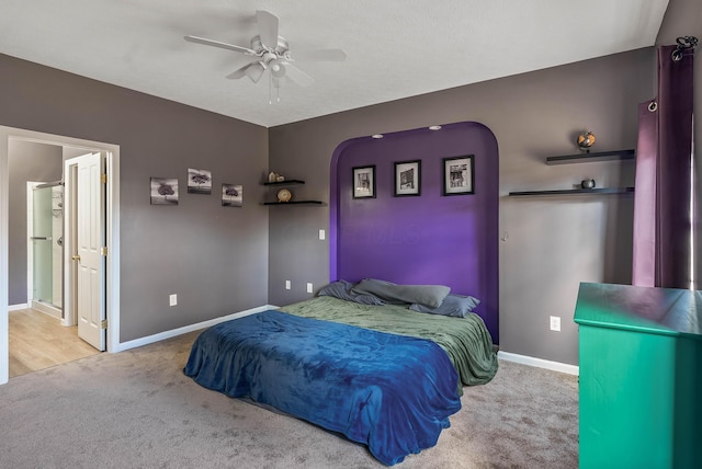 bedroom featuring a ceiling fan, carpet, arched walkways, and baseboards