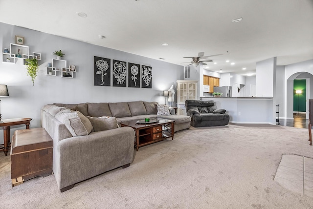 living room with arched walkways, recessed lighting, carpet flooring, a ceiling fan, and baseboards