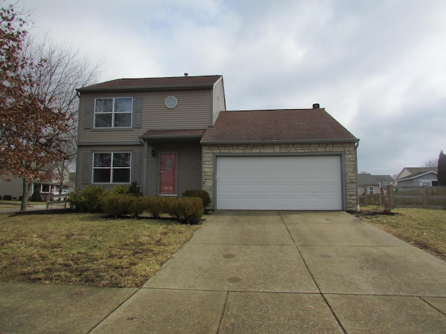 traditional-style house with a garage, fence, stone siding, concrete driveway, and a front lawn