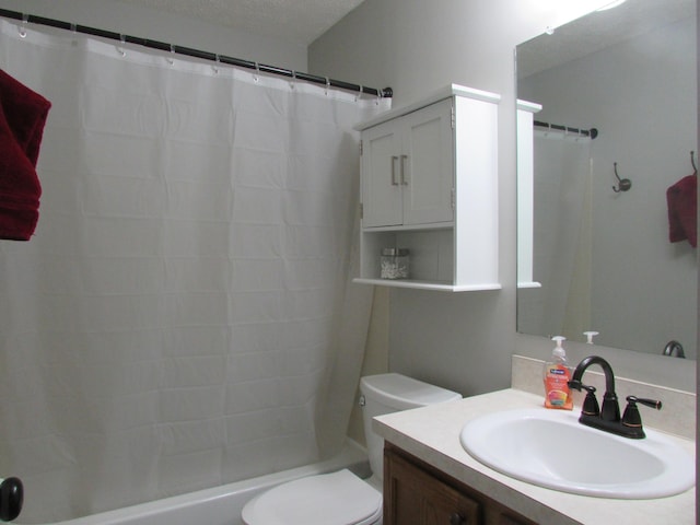 full bath featuring toilet, shower / bathtub combination with curtain, a textured ceiling, and vanity