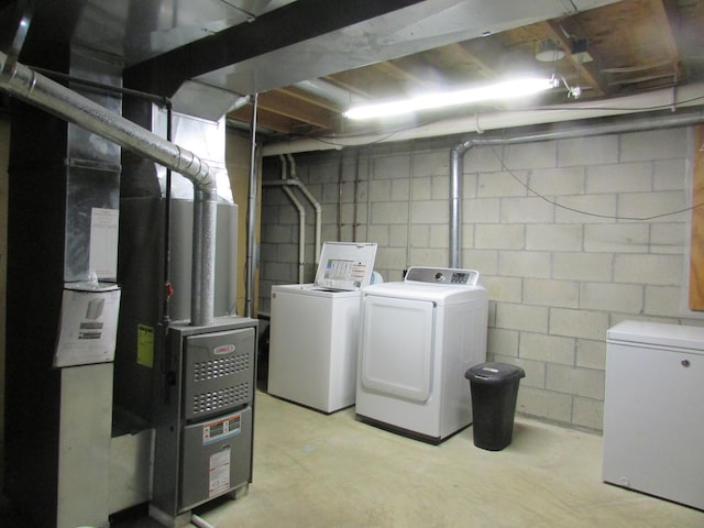 washroom with laundry area and washer and dryer