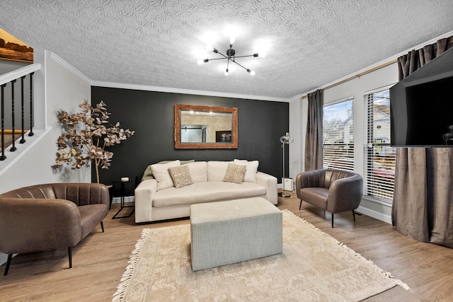 living room with ornamental molding, stairway, wood finished floors, and an inviting chandelier