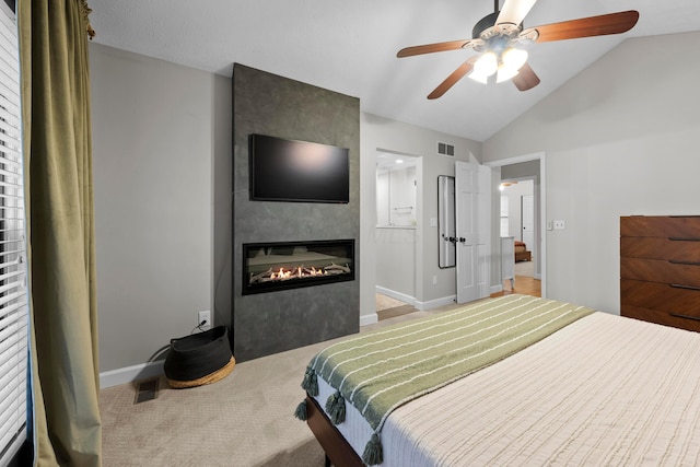 bedroom with baseboards, visible vents, vaulted ceiling, carpet floors, and a fireplace