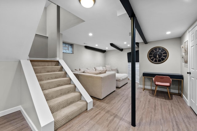 living area featuring stairs, baseboards, and wood finished floors