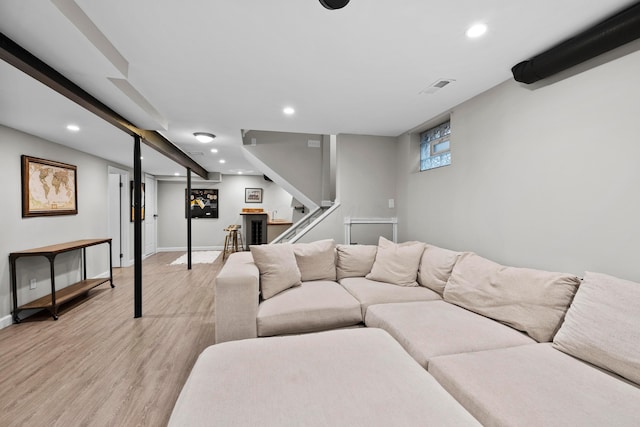 living area featuring light wood-style floors, stairway, baseboards, and recessed lighting