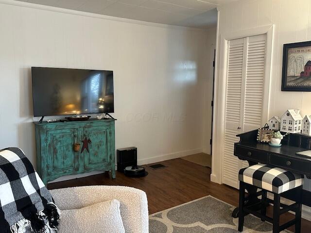 sitting room featuring baseboards and wood finished floors