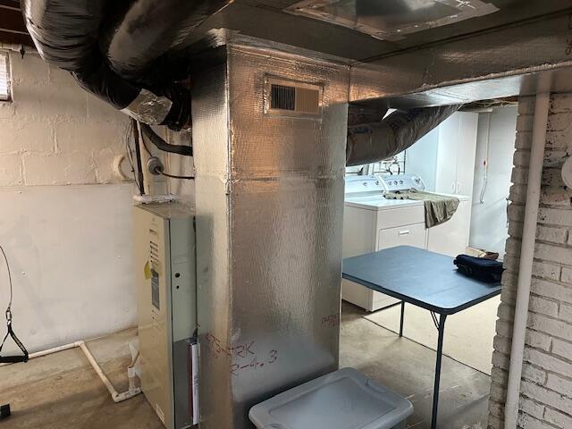 utility room with washing machine and dryer and visible vents