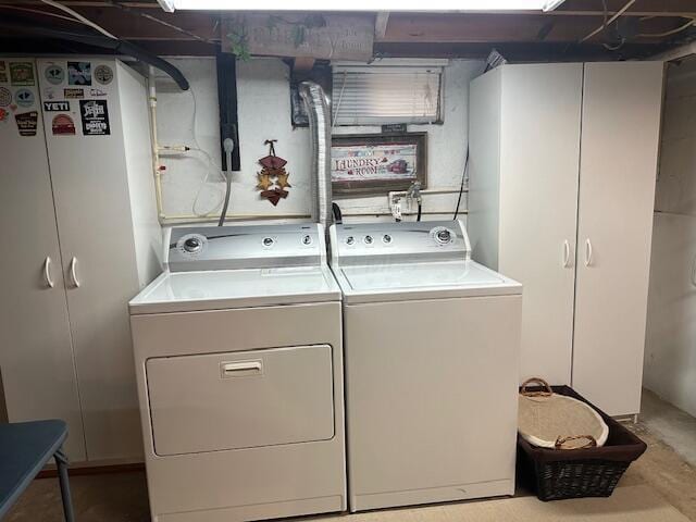 washroom featuring washer and dryer and cabinet space