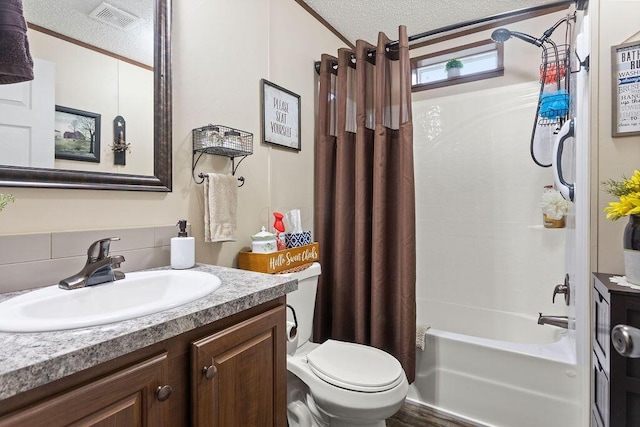 bathroom featuring toilet, visible vents, a textured ceiling, and vanity