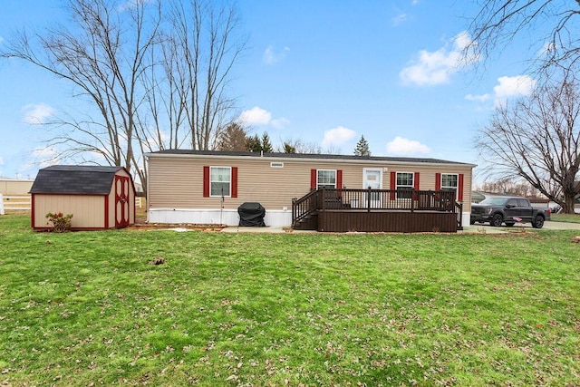 view of front facade with a storage shed, a front lawn, an outbuilding, and a wooden deck