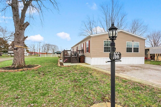 view of home's exterior with fence and a lawn