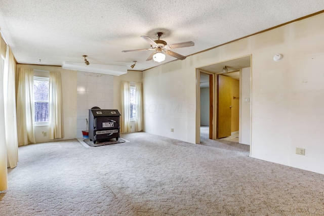 unfurnished room featuring a ceiling fan, carpet flooring, crown molding, and a textured ceiling