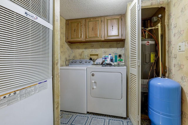 clothes washing area featuring washer and clothes dryer, cabinet space, wallpapered walls, a textured ceiling, and tile patterned floors