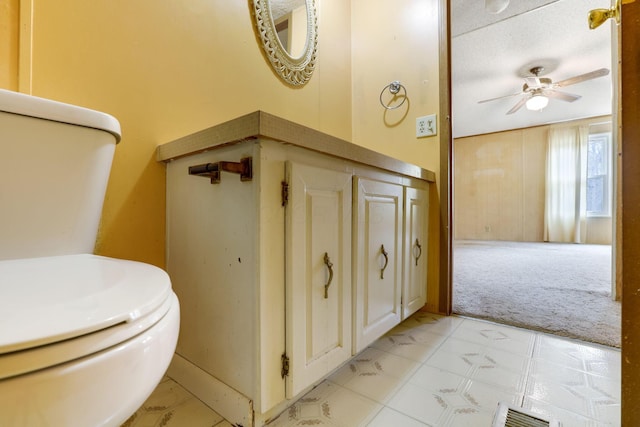 half bath featuring ceiling fan, visible vents, toilet, and tile patterned floors