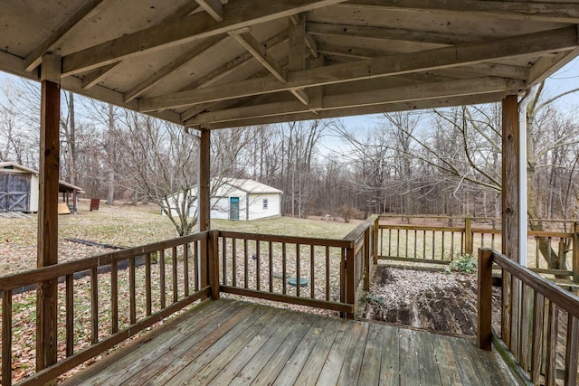 deck featuring a yard and an outbuilding