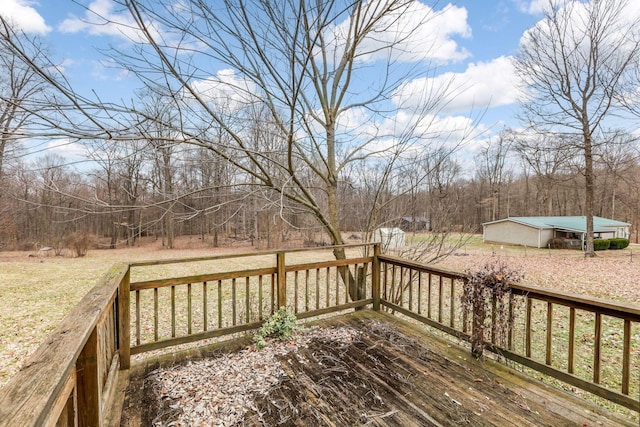 deck with an outbuilding and a forest view