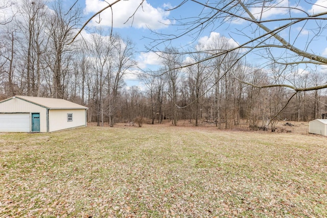 view of yard featuring an outbuilding and a detached garage