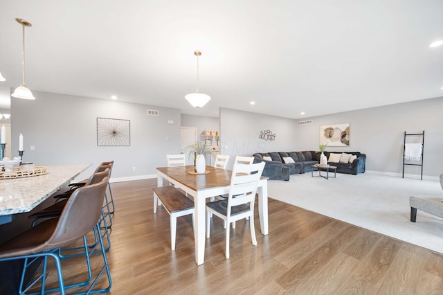 dining room featuring recessed lighting, visible vents, baseboards, and wood finished floors