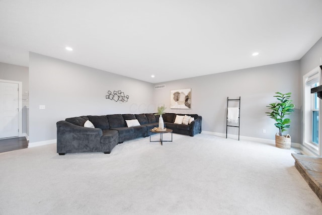 carpeted living area featuring recessed lighting, visible vents, and baseboards