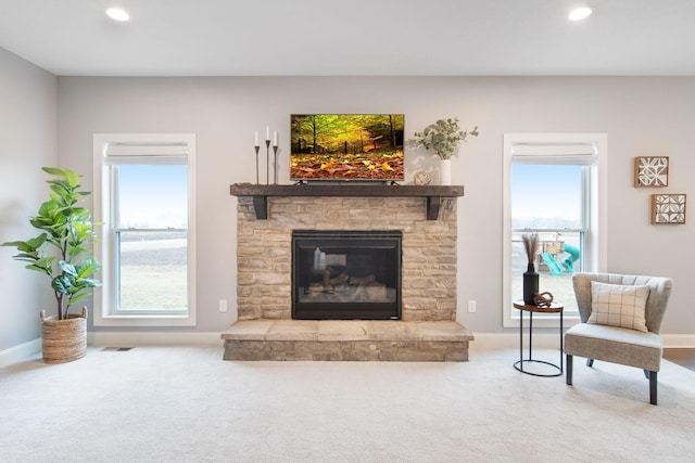 living room featuring carpet flooring, visible vents, and a wealth of natural light