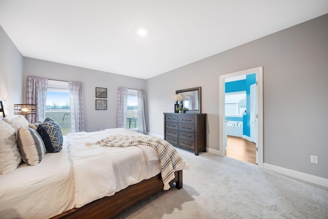 bedroom featuring baseboards and light carpet