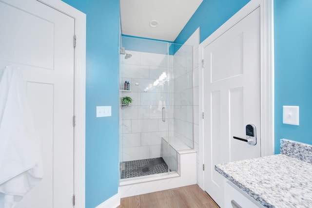 bathroom featuring a stall shower and wood finished floors