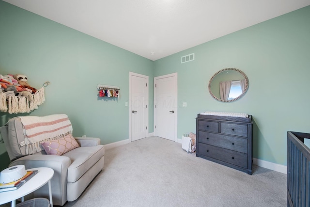 sitting room with visible vents, baseboards, and carpet floors